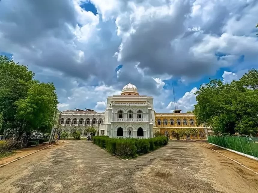 Gandhi Memorial Museum Madurai Tamil Nadu majestic white Indo-Saracenic architecture building with dome arches surrounded by trees under blue sky with clouds, historic freedom struggle tour package.