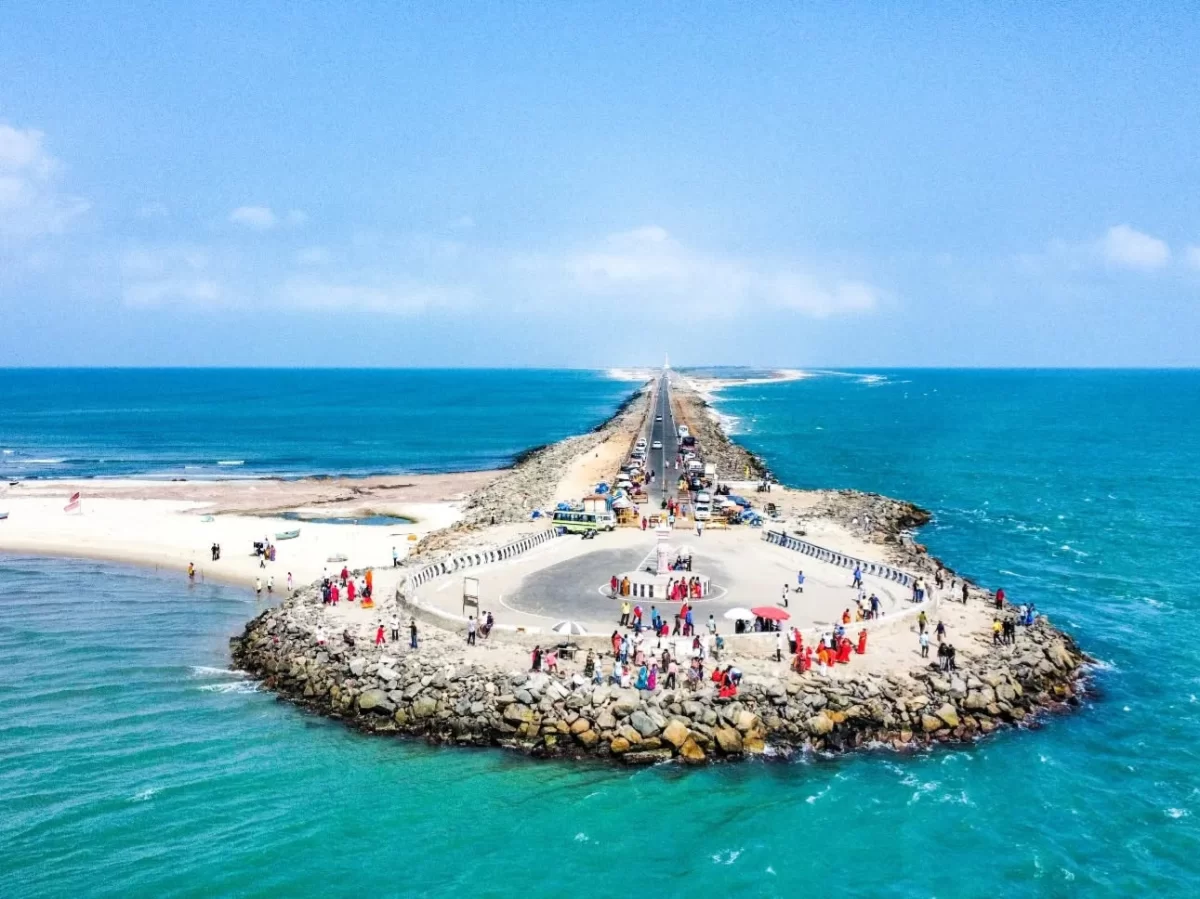 Arichal Munai Dhanushkodi Tamil Nadu aerial view Pamban road bridge connecting sandbar islands turquoise Indian Ocean Bay Bengal crowds rocks clear skies, southernmost motorable road lands end Ram Setu viewpoint Ramayana mythology site beach tourism spot.