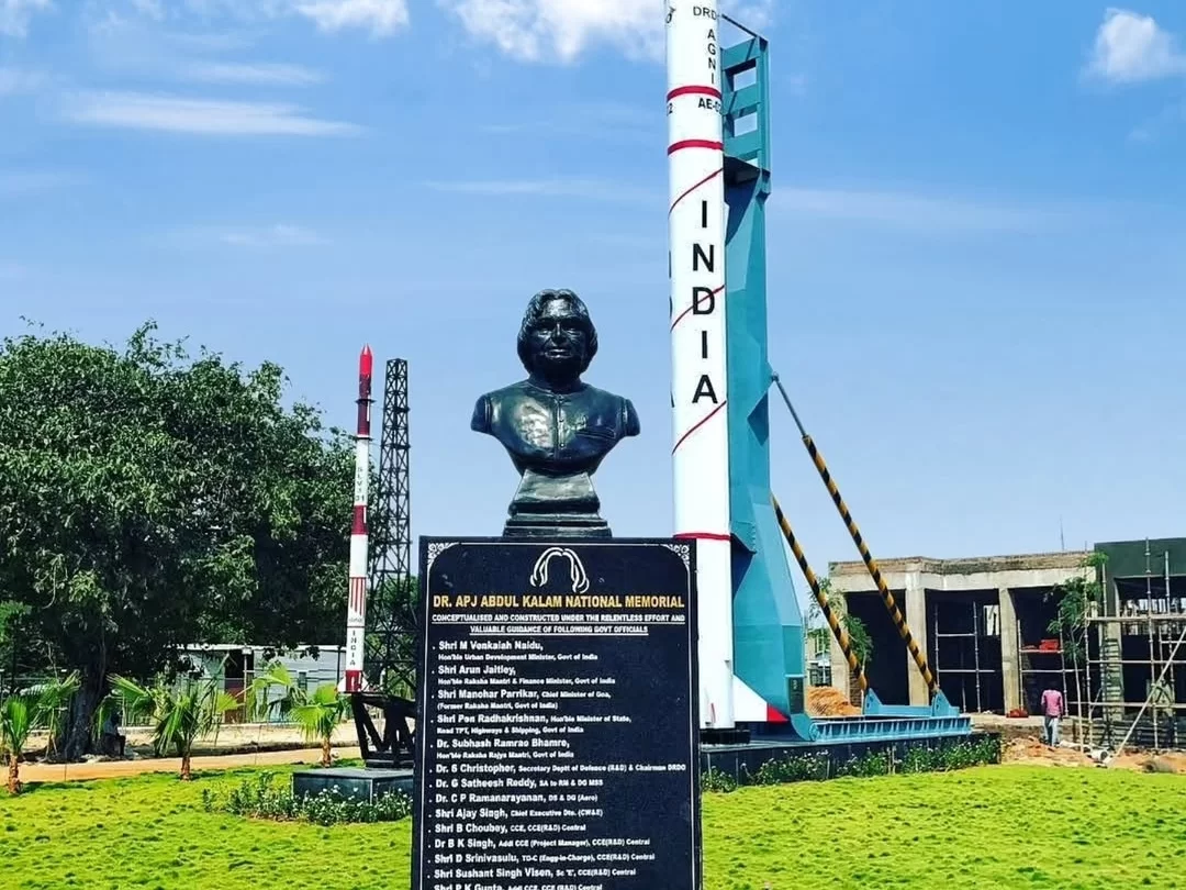 Dr. A.P.J. Abdul Kalam bust statue memorial Rameswaram Tamil Nadu India bronze bust missile man replica Agni SLV rocket launch pad model black plaque achievements honors trees green lawn construction background sunny blue skies, perfect ISRO missile herit