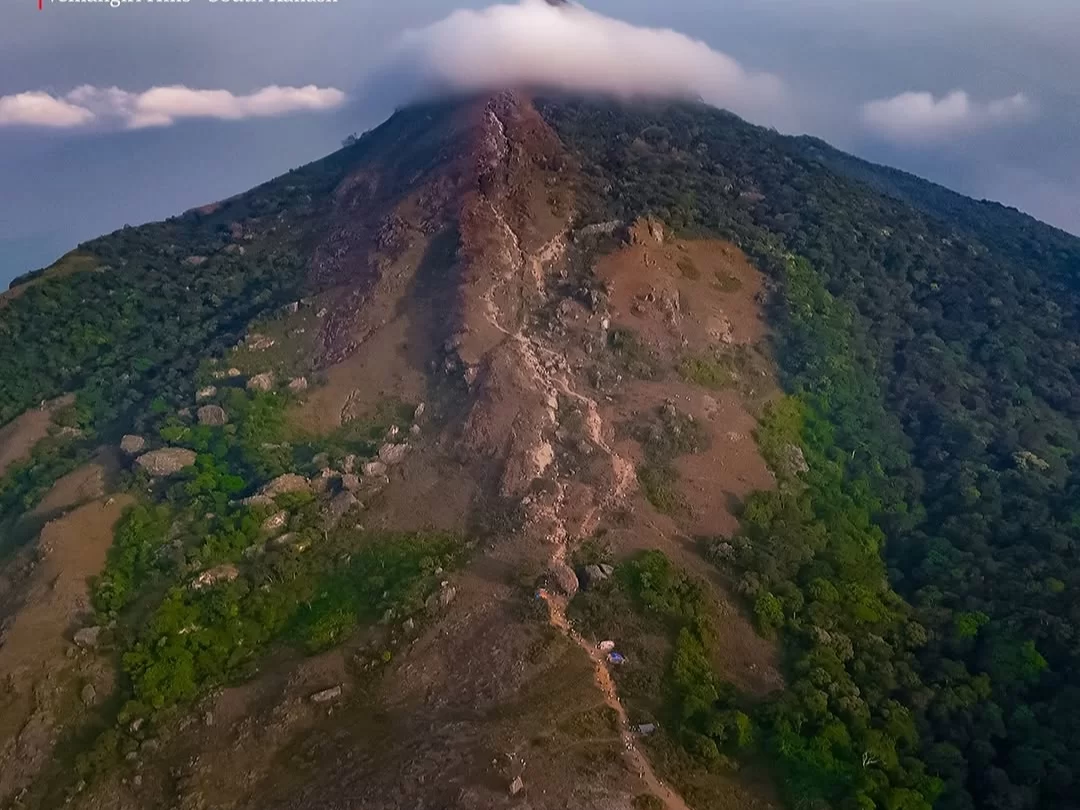 Velliangiri Hills aerial drone view mist-shrouded peak rugged rocky trails dense green forests Tamil Nadu Western Ghats, challenging seven-hill Shiva pilgrimage trek Coimbatore spiritual adventure
