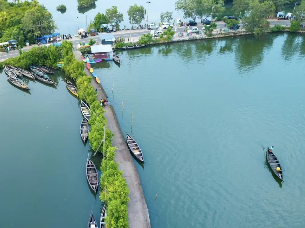 Munroe Island aerial view Kerala backwaters with docked houseboats cars tourists pathway mangroves canal, perfect eco tourism houseboat package.