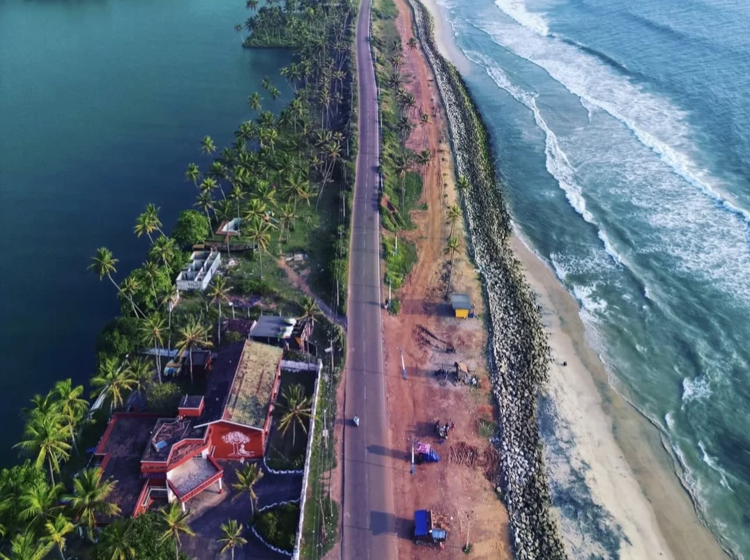 Kappil Beach Varkala Kerala aerial view coastal road sea lake divide, palm groves red sands waves turquoise backwaters, perfect Kerala confluence beach package.