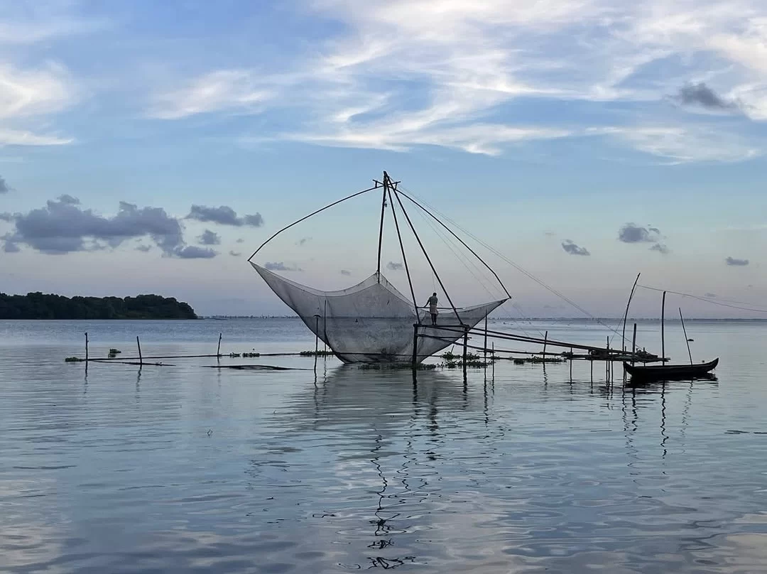 Vembanad lake Kerala Chinese fishing net white pyramid frame fisherman sunset blue waters clouds palm island traditional backwaters, perfect houseboat eco tourism package.