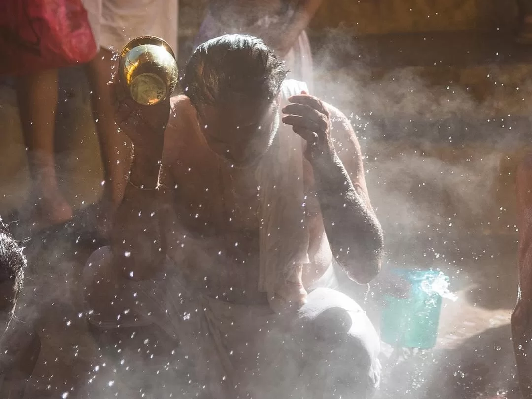 Tapt Kund Badrinath hot spring pilgrims bathing gold pot steam white cloth dhoti green bucket Char Dham Yatra spiritual purification ritual.