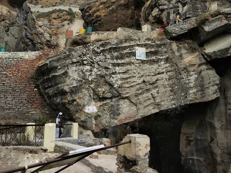 Bheem Pul Mana Village Badrinath massive rock bridge railing tourists colorful structures rocky gorge Uttarakhand tour packages.