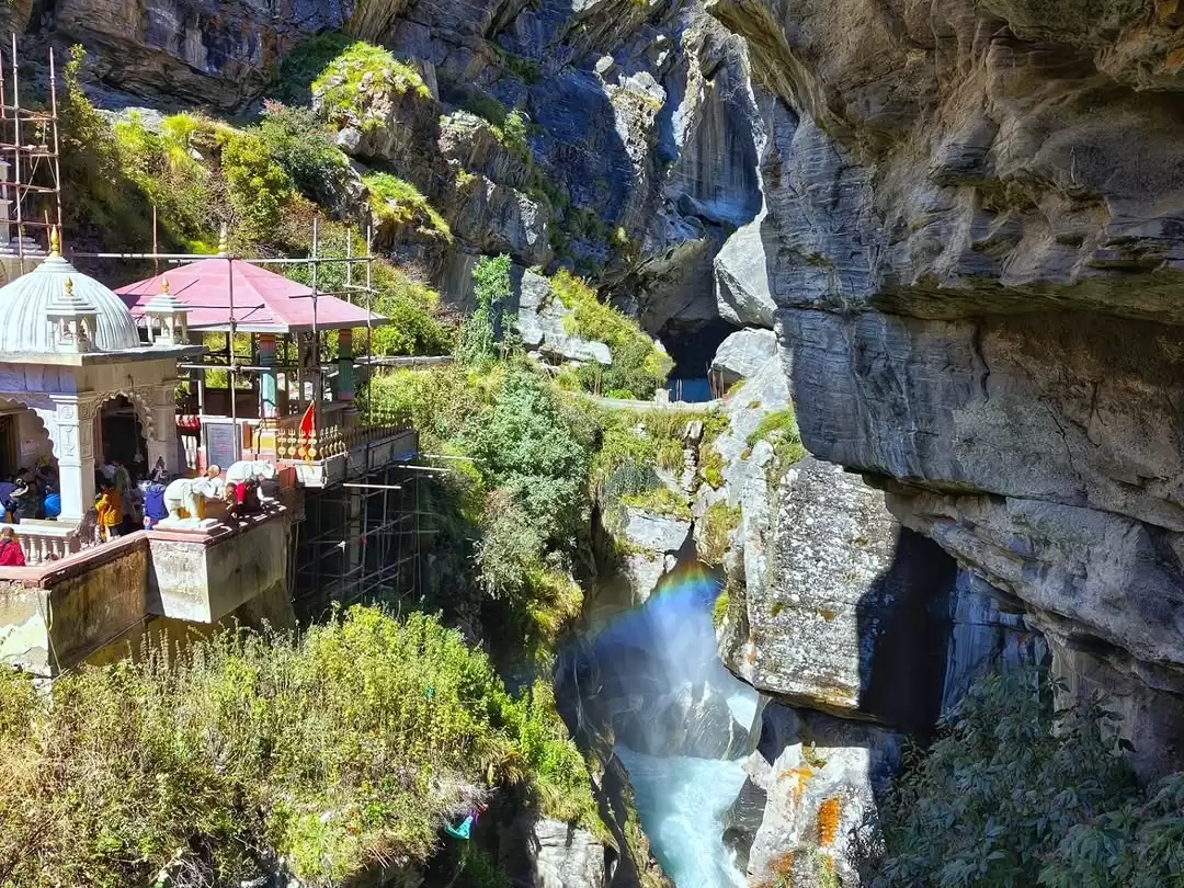Bheem Pul Mana Village Badrinath temple white temple pink scaffolding green hills rocky river gorge tourists Uttarakhand tour packages. 
