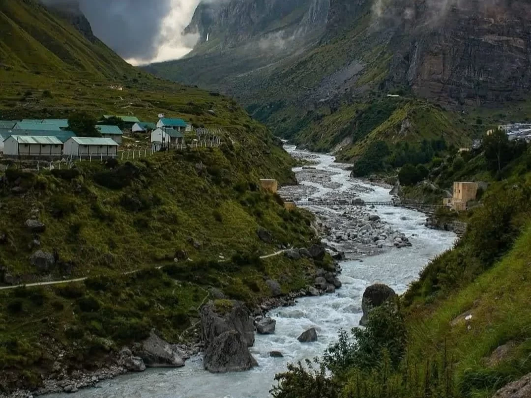 Mana Village Uttarakhand green roof cottages rocky river valley misty snowy mountains Badrinath India's last village Uttarakhand tour packages.