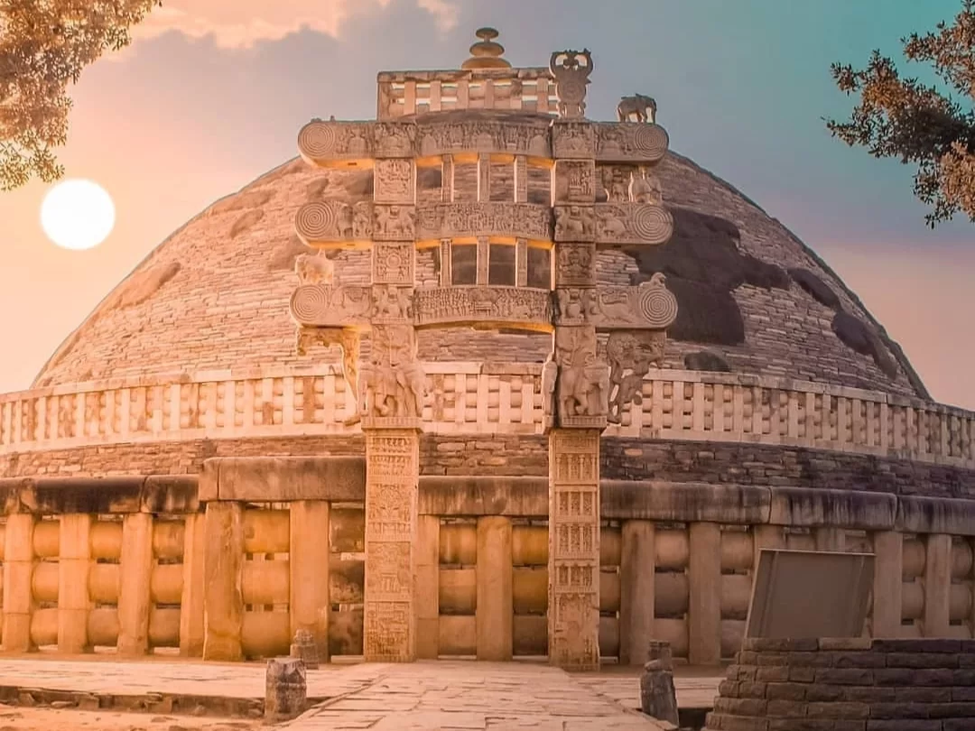 Great Stupa at Sanchi during golden sunset, featuring Torana carvings with elephants and moon crescent, perfect heritage experience in Madhya Pradesh tour package.