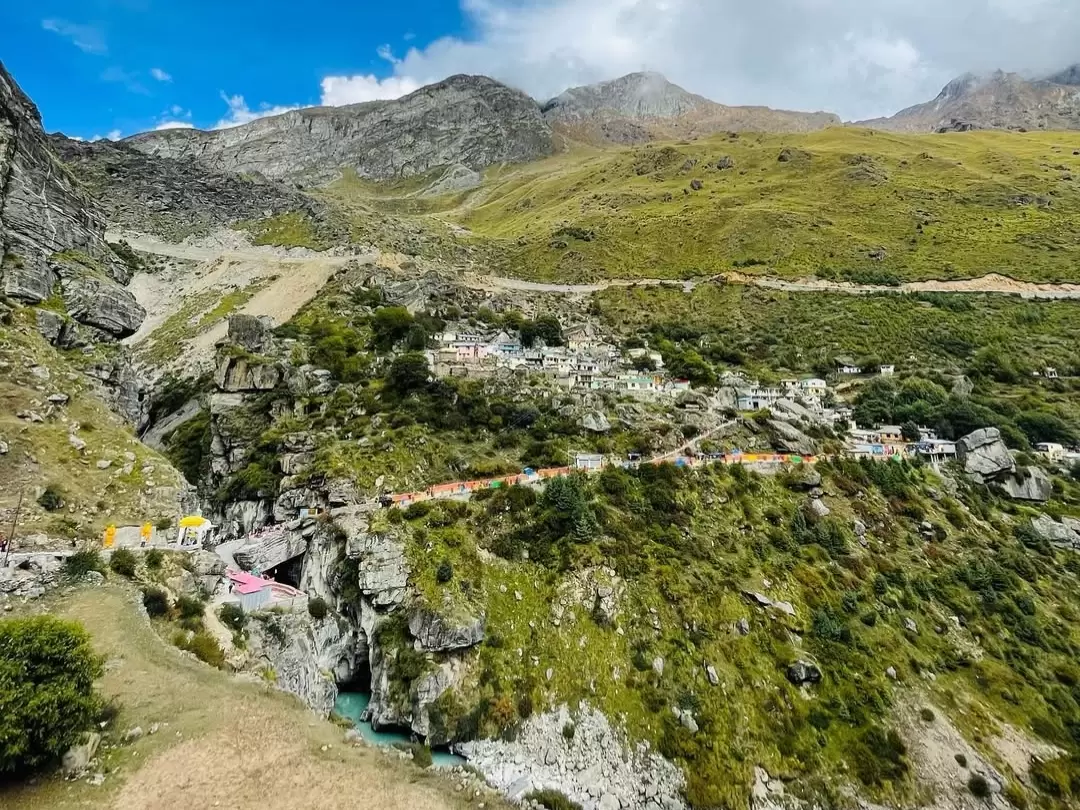 Mana Village Uttarakhand colorful houses road terraced green fields rocky snowy mountains blue sky Badrinath last village Uttarakhand tour packages. 