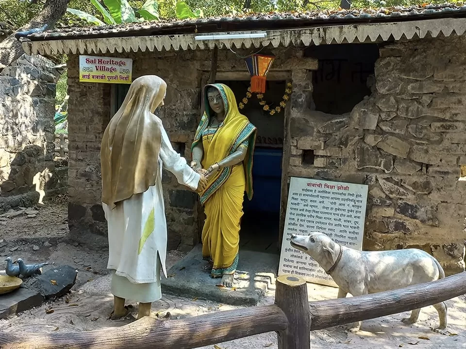 Sai Baba procession statues at Sai Heritage Village near Naini Lake Nainital, featuring drummers, musicians, devotees, little girl and Sai Baba under umbrella, perfect cultural heritage experience Uttarakhand tour package.