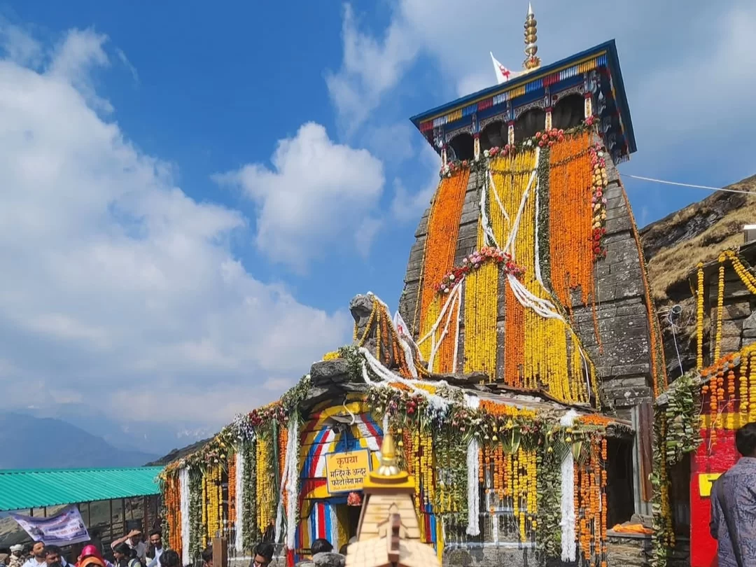 Tungnath Temple decorated during festival day, featuring marigold garlands & prayer flags on hills, perfect adventure experience Uttarakhand tour packages.