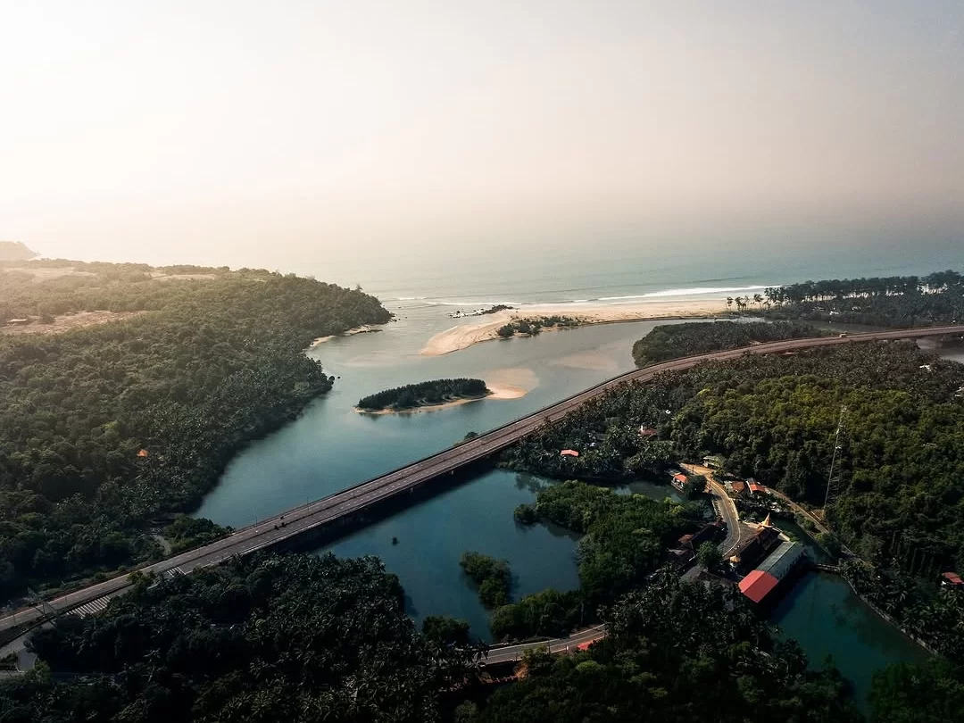 Aerial Galgibaga Beach Goa river estuary sandbar bridge, lush forests golden hour sands Arabian Sea palms villages, perfect South Goa eco turtle nesting beach package.