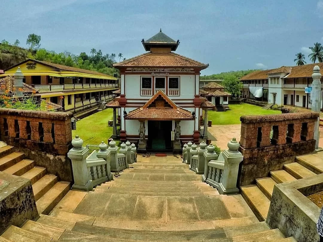 Grand Mallikarjuna Temple Canacona South Goa Kerala architecture courtyard, orange tile roof white red walls palm hills, perfect Goa Shiva heritage temple complex package. 