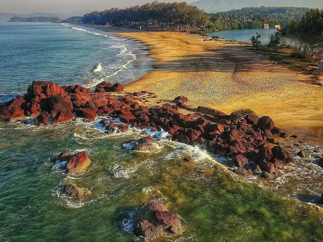 Aerial Colva Beach South Goa golden sands Arabian Sea estuary palms, red rock waves turquoise lagoon casuarina trees, perfect Goa pristine beach aerial view package.