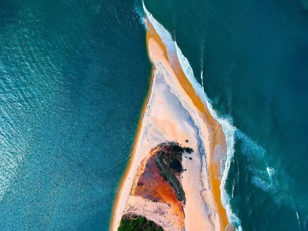 Mobor Beach South Goa aerial sand spit Arabian Sea Sal River mouth, golden orange beach turquoise waters waves rocks palms, perfect Goa serene spit beach package.