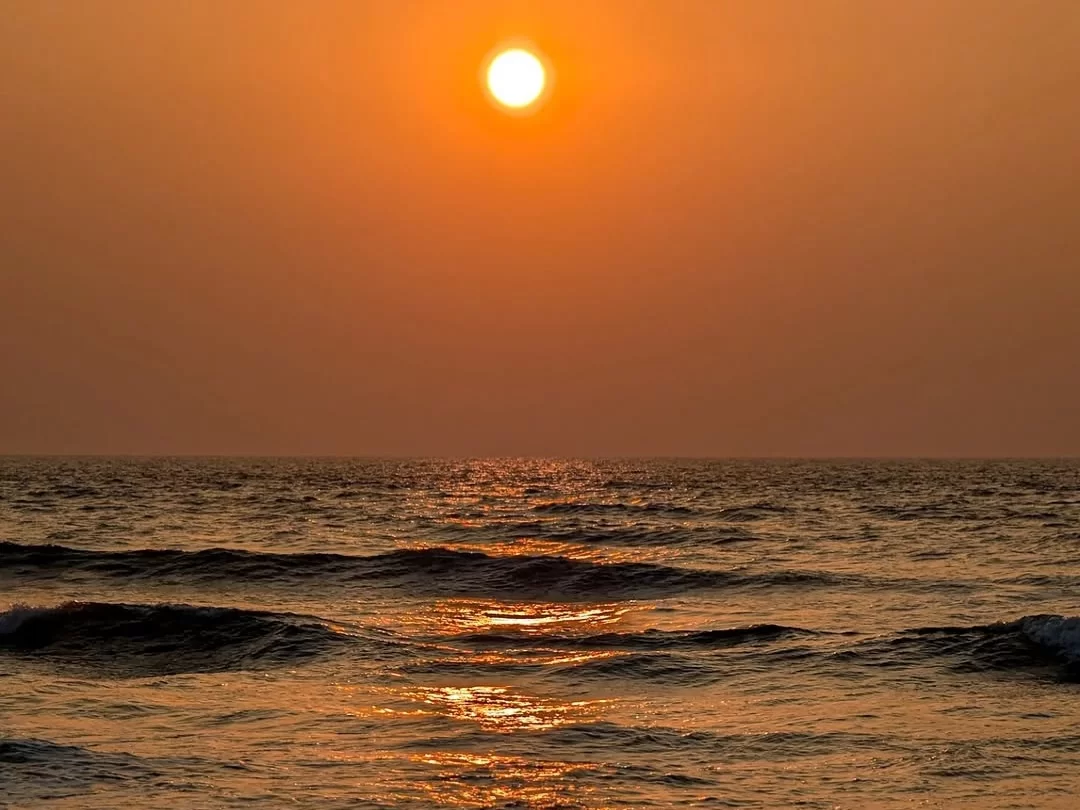 Mobor Beach South Goa perfect orange sunset ball ocean horizon, dark waves golden glow serene waters, perfect Goa tranquil beach sunset package.