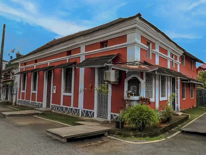 Red and yellow Portuguese style houses in Fontainhas Latin Quarter Panaji Goa, featuring arched windows sunset sky palm accents, perfect heritage experience Goa heritage walking tour package.
