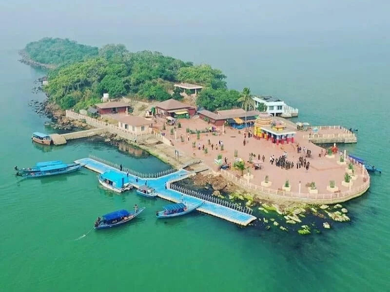 Chilika Lake Kalijai Island Odisha aerial tourists blue floating jetty motorboats temple complex lush greenery, perfect Puri birdwatching boat safari tour package. 