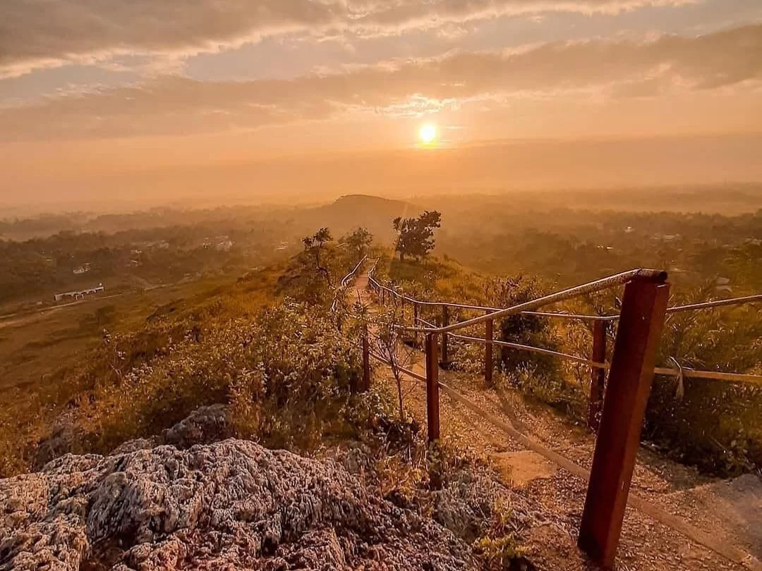 Sunset trail at Biswanath Hill Delang Puri Odisha during golden hour, featuring handrails, hill path, panoramic views, perfect adventure experience Odisha tour package. 