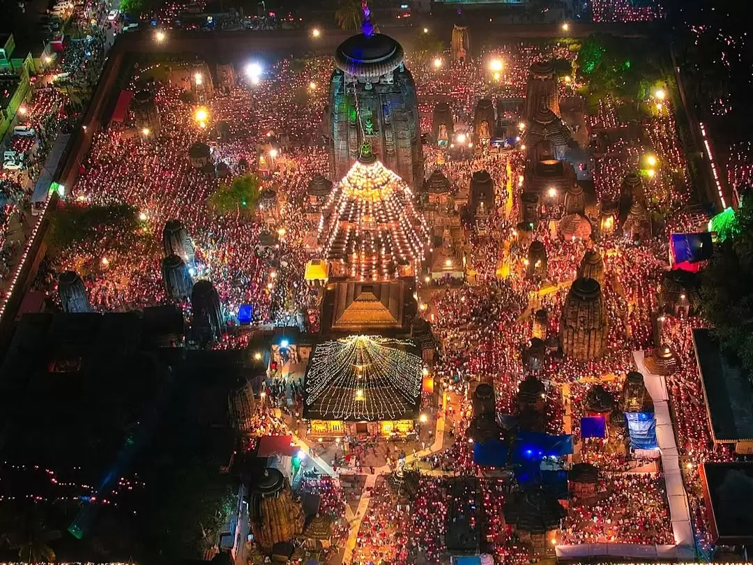 Shree Jagannath Temple at Puri during festival night, featuring illuminated spires, crowded lamps, colorful lights, perfect spiritual experience with Odisha Puri tour package. 