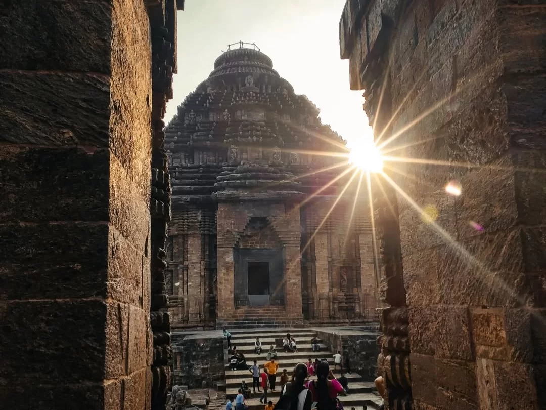 Jagamohana at Konark Sun Temple Odisha during sunset, featuring stone shikhara dome, carved pillars, crowds, misty rays, perfect heritage experience Odisha tour package. 
