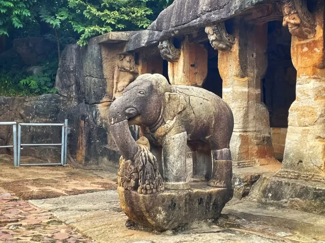 Udayagiri Caves Odisha Ganesha Gumpha elephant statue trunk lotus foliage rock-cut pillars entrance, perfect Bhubaneswar Jain heritage tour package.