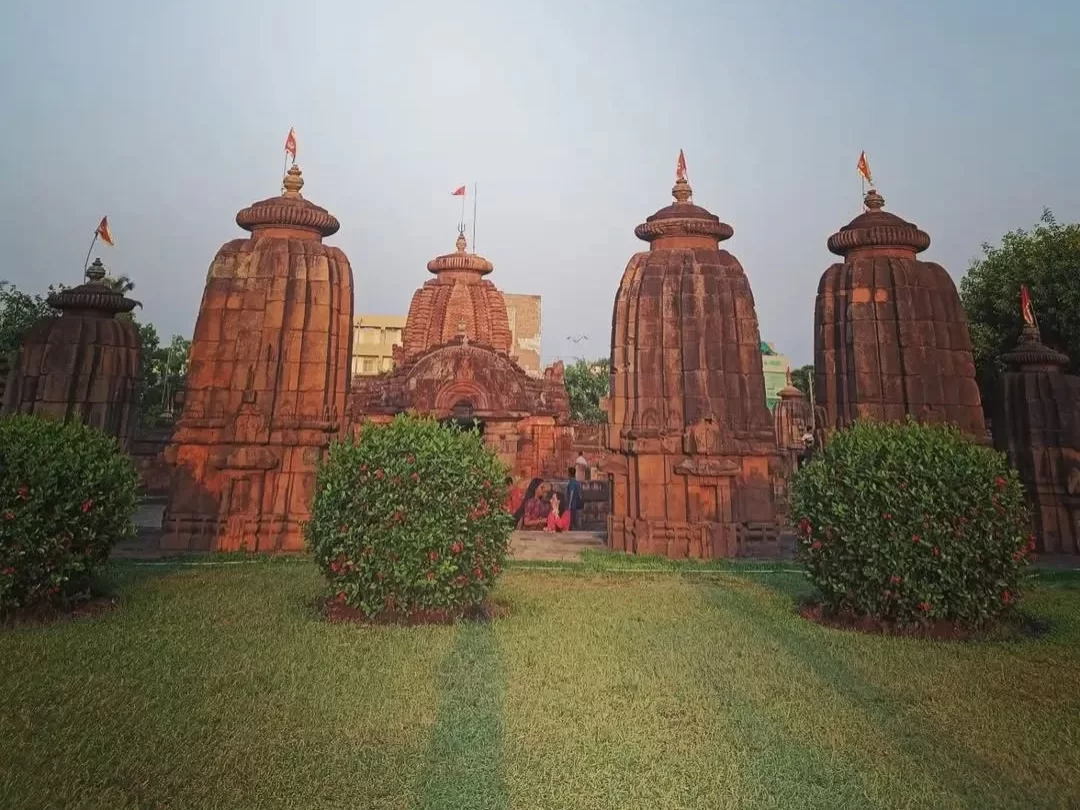 Mukteswara Temple complex at Bhubaneswar during golden hour, featuring multiple Kalinga Nagara spires with flags, perfect Odisha heritage tour package.