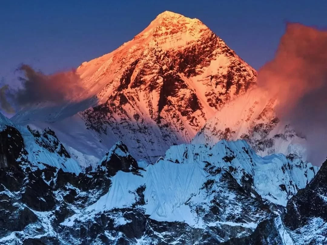 Adi Kailash peak during golden sunset, featuring alpenglow summit, clouds and snowy ridges, perfect spiritual Uttarakhand tour package.