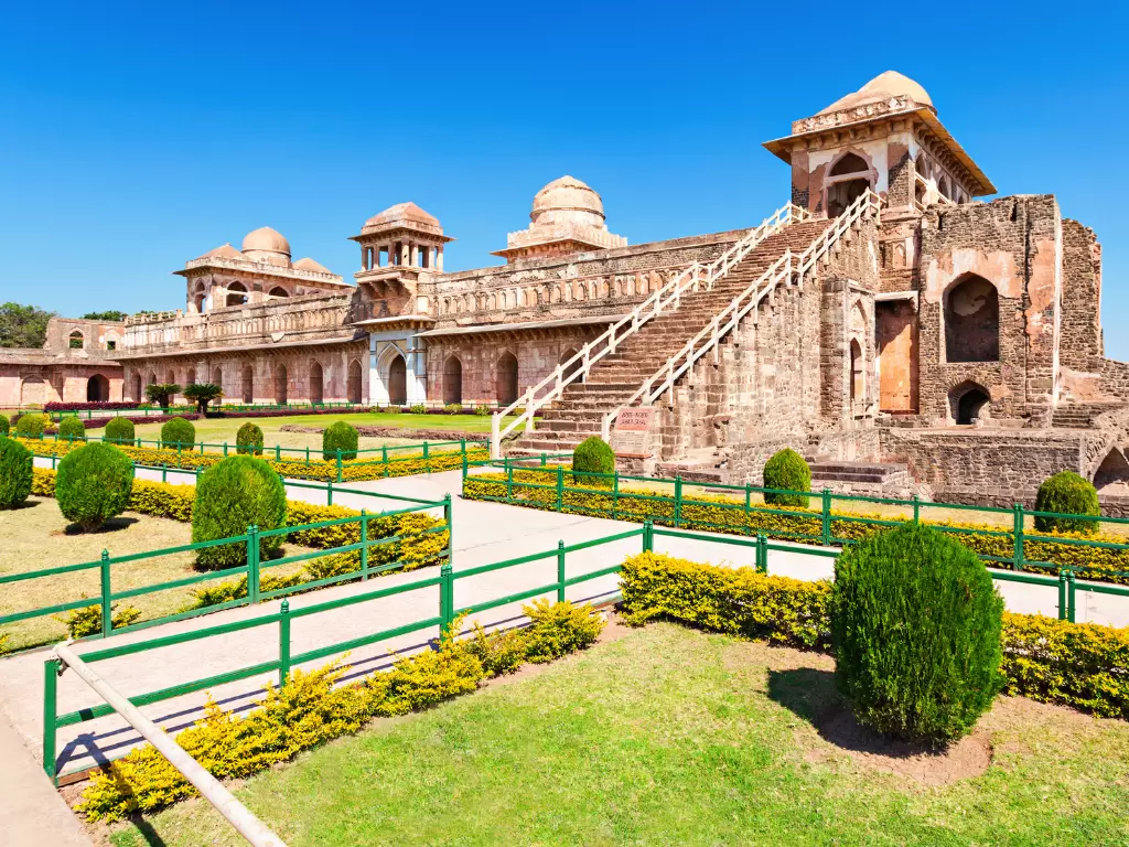 Jahaz Mahal at Mandu under clear skies, featuring grand staircase domes and manicured gardens, perfect heritage experience with Madhya Pradesh tour packages.