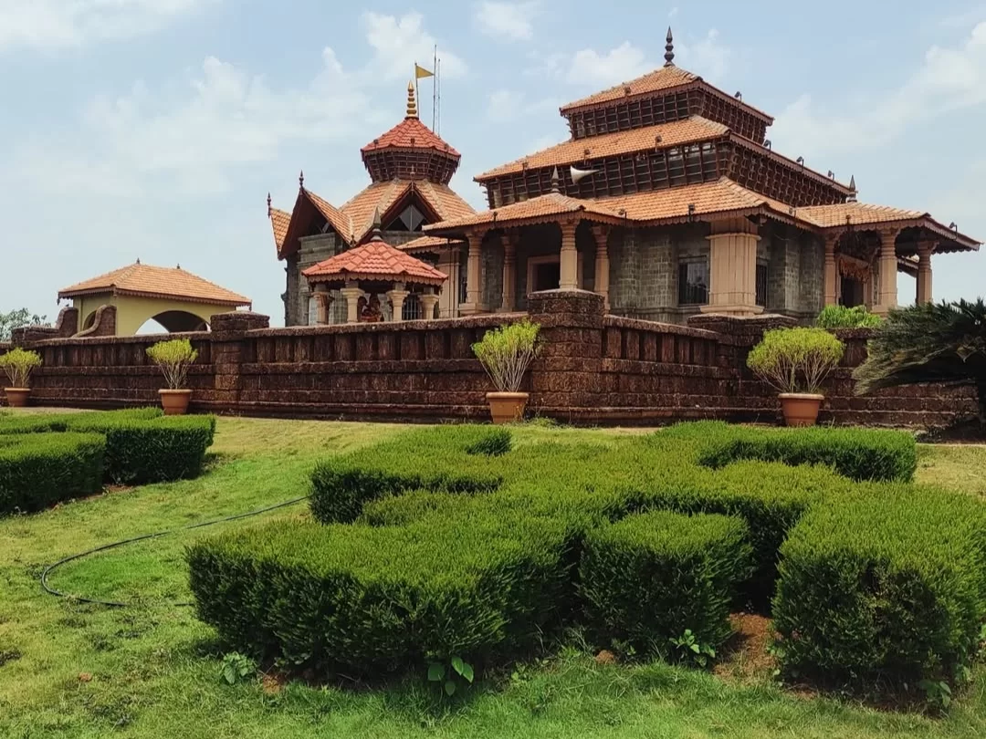 Jai Vinayak Mandir in Maharashtra showcasing traditional temple architecture with tiled roofs, stone walls and landscaped gardens, a peaceful spiritual attraction included in Maharashtra tour packages