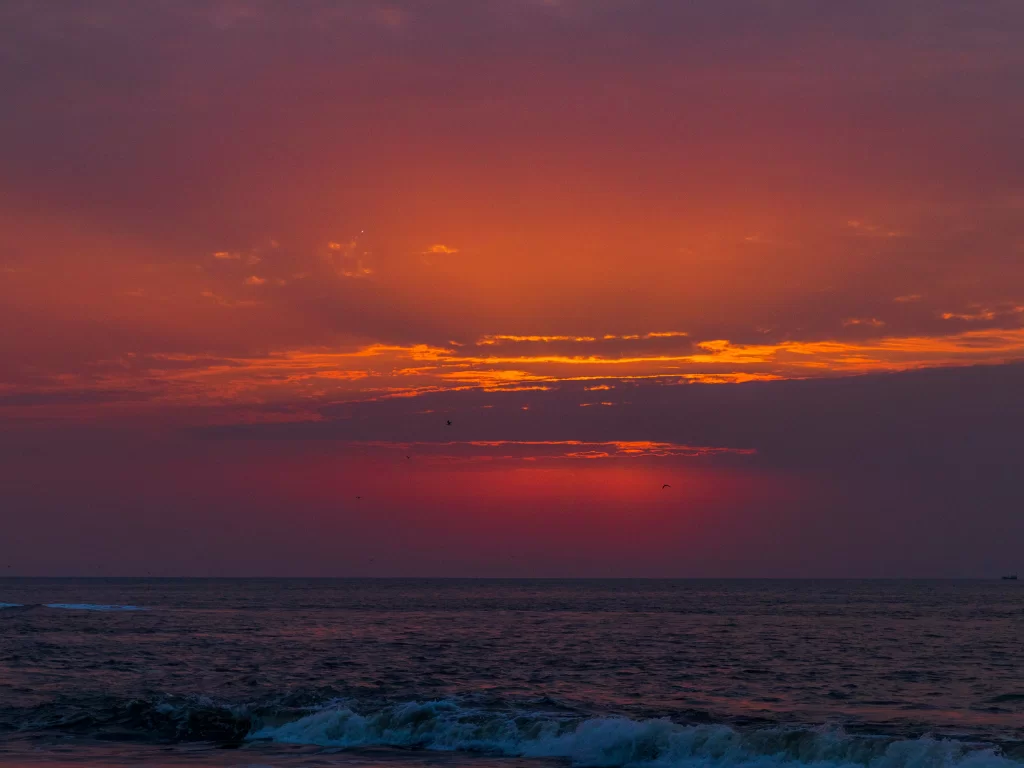 Sunset at Jalandhar Beach Diu during golden hour, featuring Arabian Sea waves and vibrant skies, perfect romantic experience Diu tour package.