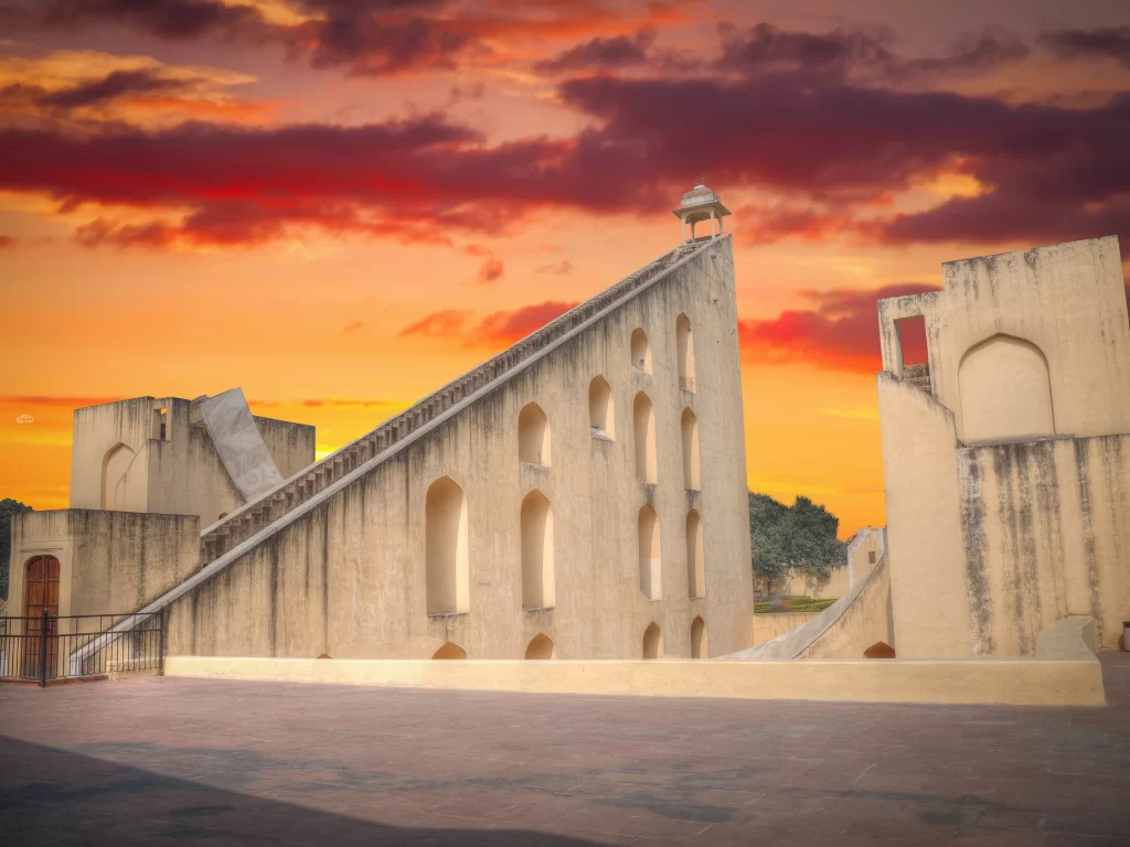 Samrat Yantra at Jantar Mantar Jaipur during sunset, featuring massive stone sundial and dramatic sky, perfect heritage experience Rajasthan tour packages.