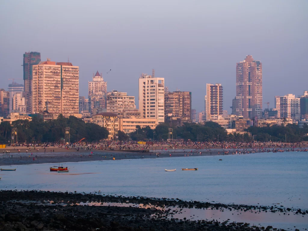 Juhu Beach Mumbai golden hour skyline crowd fishing boats Arabian Sea palm trees, perfect Mumbai beach sunset street food celebrity spotting package. 