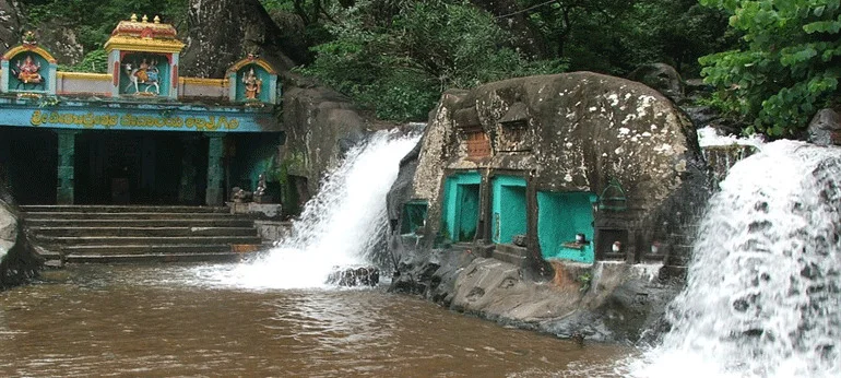 Kallathigiri Falls in Chikkamagaluru during daylight, featuring cascading waterfalls and lush forest, perfect nature experience, Karnataka tour packages.