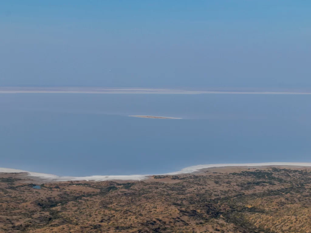 Kalo Dungar panoramic view of Great Rann of Kutch during clear day, featuring vast salt desert expanse, arid foreground hills and distant horizon, perfect adventure experience with Gujarat tour packages.