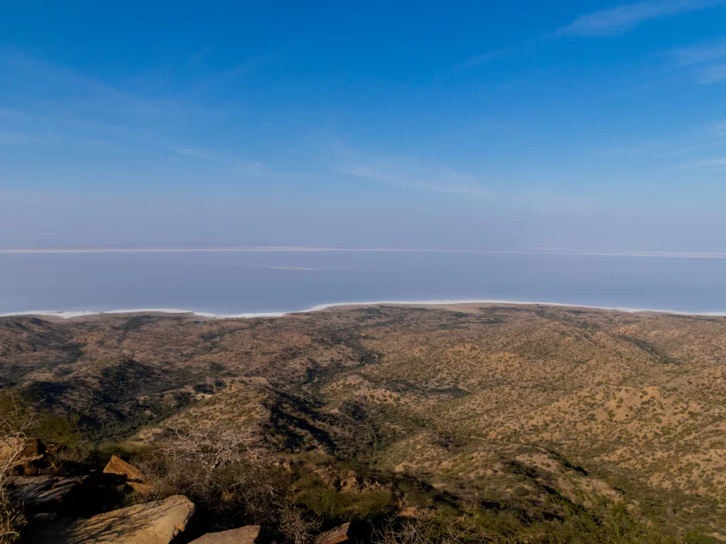 Kalo Dungar viewpoint at Kutch during clear day, featuring Great Rann salt desert panorama, arid hills and endless white expanse, perfect adventure experience with Gujarat tour packages.