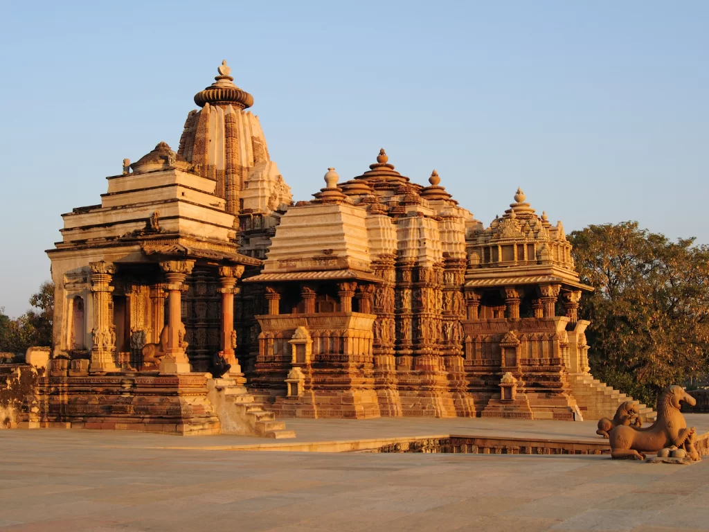Kandariya Mahadeva Temple Khajuraho golden hour side view Western Group UNESCO site, tallest Nagara shikhara 31m 84 urushringas Shiva shrine intricate carvings Chandela Vidyadhara 1025-1050 CE, ideal Madhya Pradesh heritage tour package.