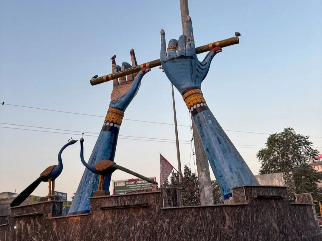 Shree Khatushyam Temple grand Krishna flute statue landmark with peacock sculptures in Rajasthan tour packages.