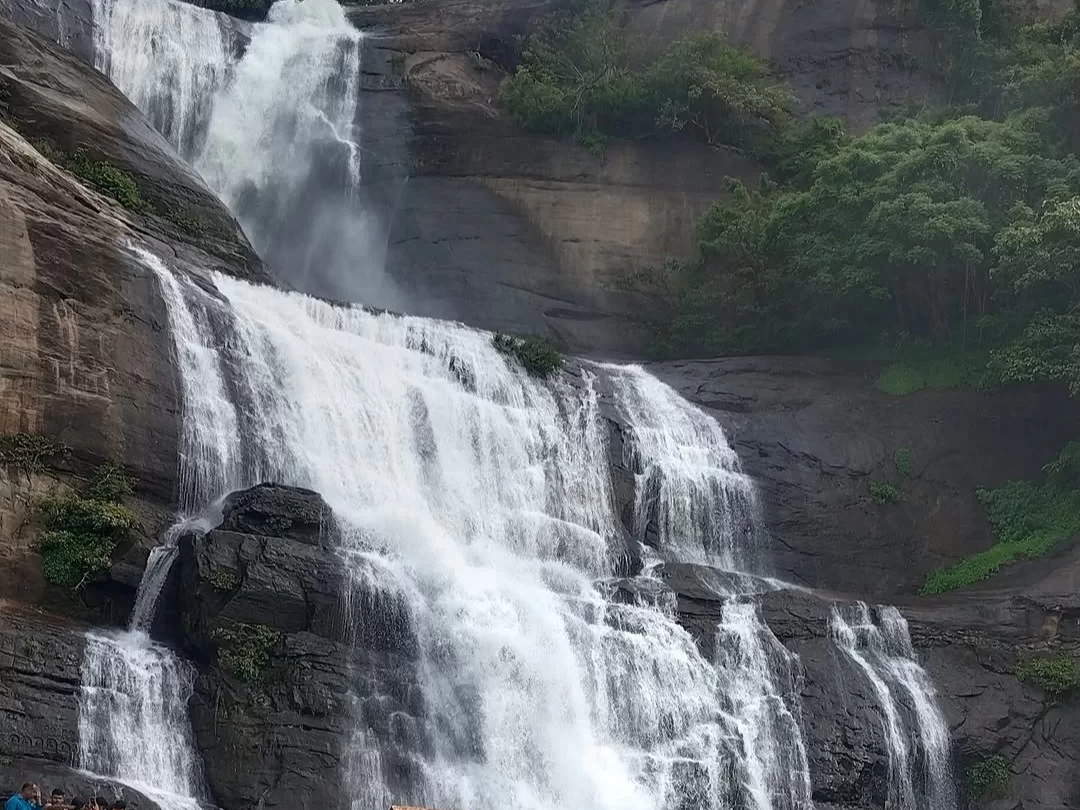 Kovai Kutralam Waterfalls, scenic cascade near Coimbatore in Siruvani hills surrounded by lush forest and rocky cliffs
