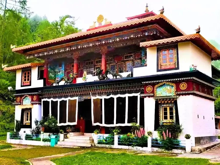Lachung Monastery Sikkim ornate red-gold facade with prayer flags amid pine forests, perfect cultural North Sikkim tour package.
