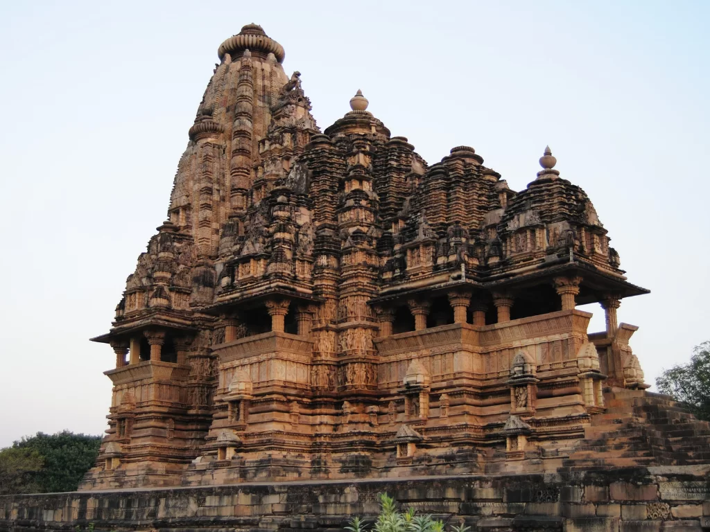 Lakshmana Temple Khajuraho Western Group UNESCO site, Nagara-style Vaikuntha Vishnu three-headed shrine Chandela dynasty 930-950 AD intricate carvings, ideal Madhya Pradesh heritage temple tour package.