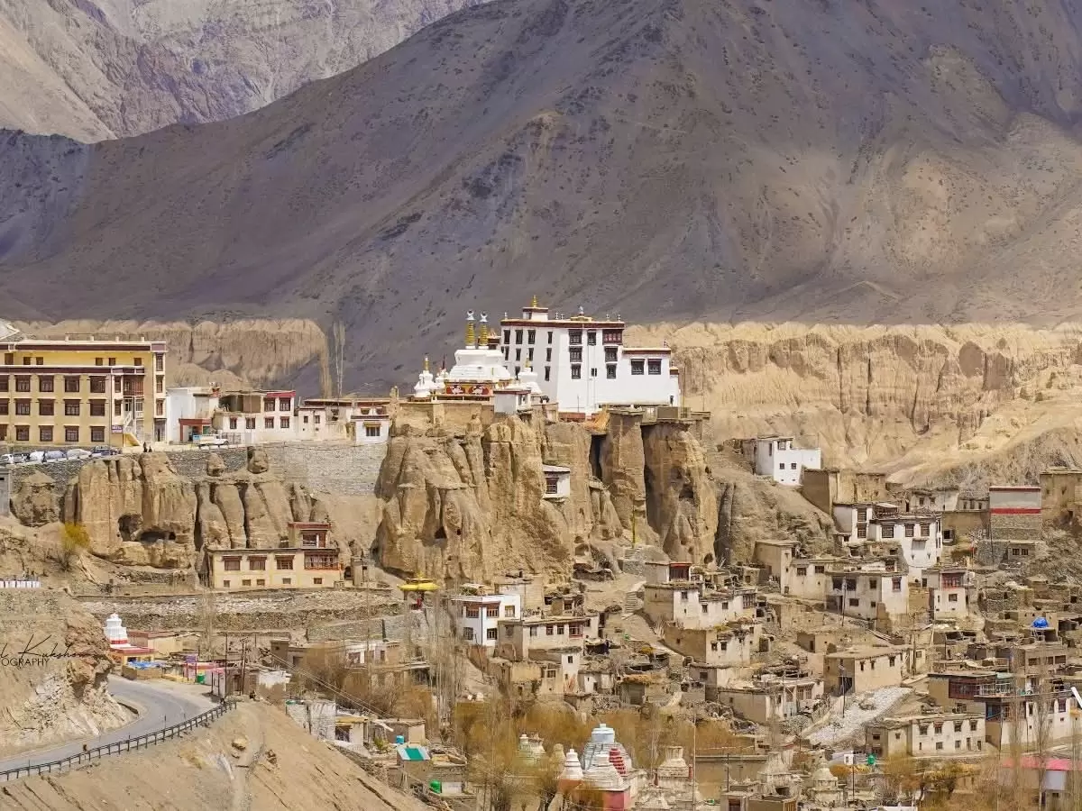 Lamayuru Monastery Ladakh iconic moonland panorama with white gompa perched on eroded cliffs amid rugged Himalayan peaks and village, top attraction on Leh Kargil highway in Ladakh tour packages