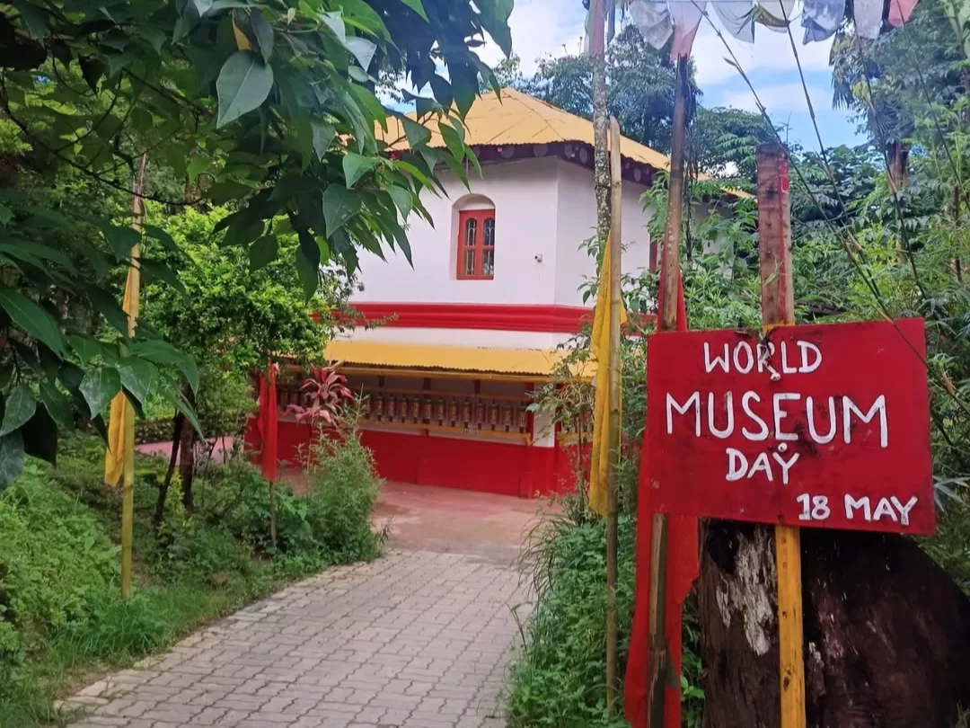 Lepcha Museum in Kalimpong, West Bengal, surrounded by greenery with traditional architecture and a pathway entrance, a cultural attraction highlighting local heritage and featured in West Bengal tour packages.