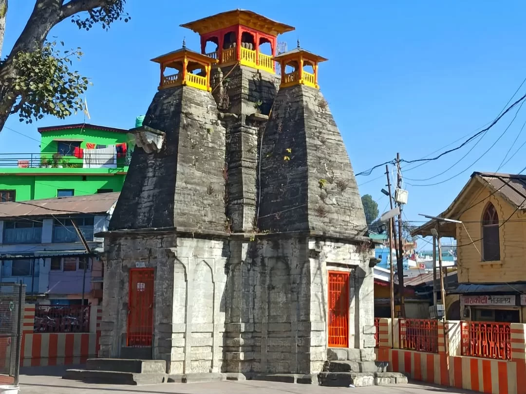 Maa Nanda Devi Temple in Almora, Uttarakhand featuring its tall stone structure and vibrant red doors, a revered cultural landmark included in Uttarakhand tour packages