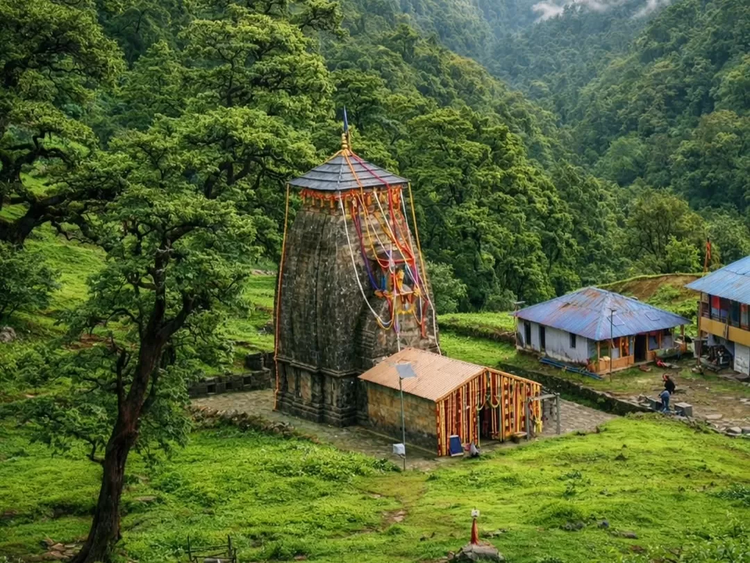 Madhyamaheshwar Temple ancient Himalayan Shiva shrine surrounded by lush green meadows and trekking routes in Kedarnath region Uttarakhand tour packages