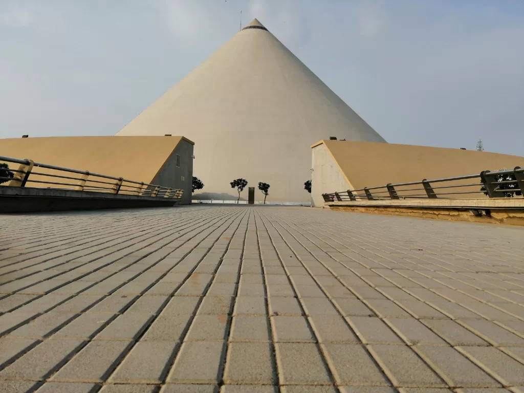 Mahatma Mandir Convention Centre at Gandhinagar during clear day, featuring pyramid memorial structure with approach plaza, perfect convention experience with Gujarat tour packages.