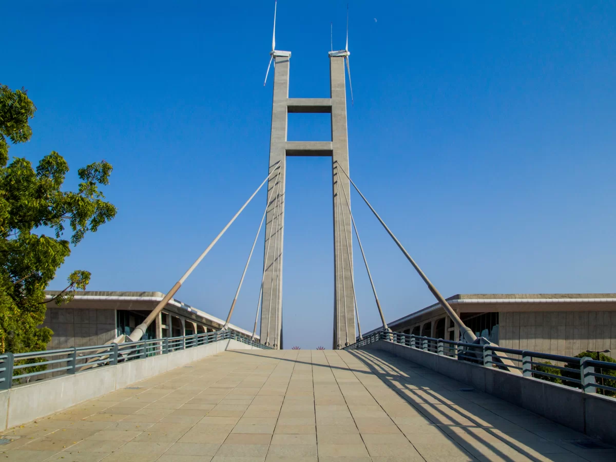 Mahatma Mandir Convention Centre at Gandhinagar during clear day, featuring cable-stayed bridge with windmill towers, perfect convention experience with Gujarat tour packages.