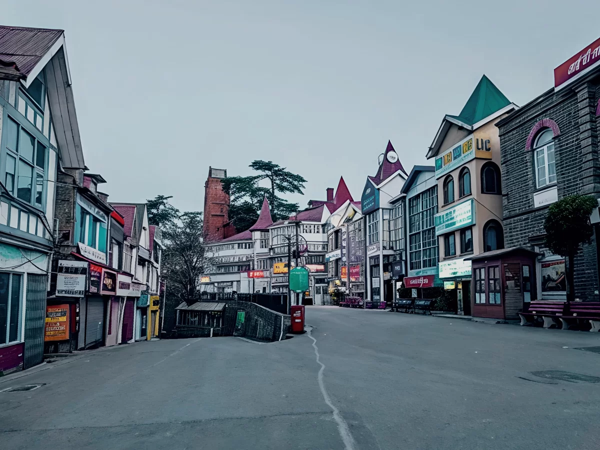 Vibrant colonial buildings on Mall Road Shimla during dawn, featuring shops, clock tower, deodar trees, perfect shopping stroll, Himachal Pradesh tour packages.