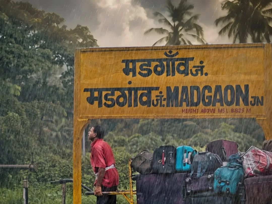 Margao Goa railway station signboard in South Goa with luggage carts during monsoon rain