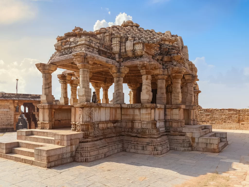 Close-up of Meera Temple pavilion at Chittorgarh Fort in Rajasthan with ornate pillars, steps and shikhara under blue sky, perfect Rajasthan tour package